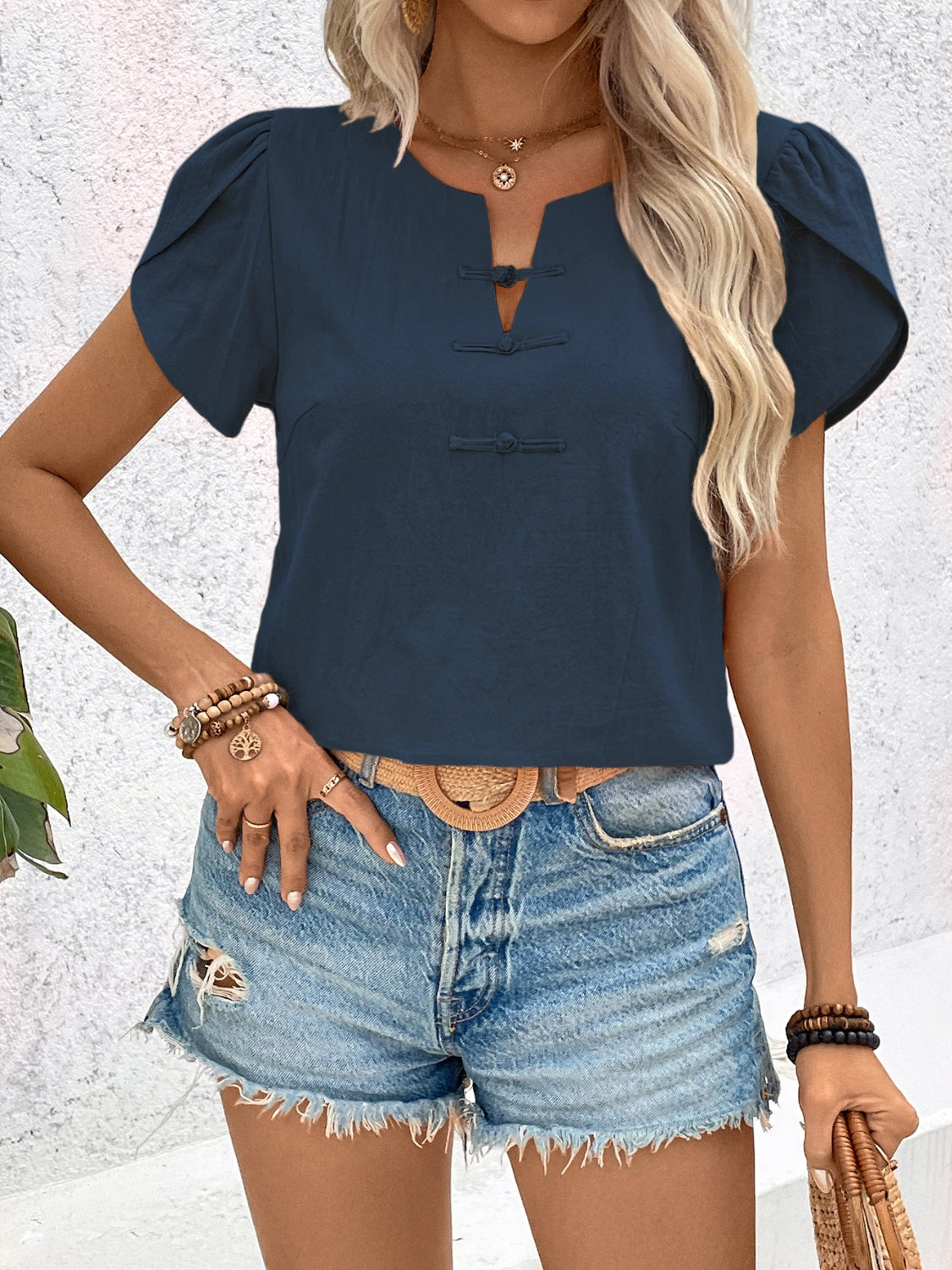 Indigo linen blouse with mandarin collar, puff sleeves, and frog button detail.