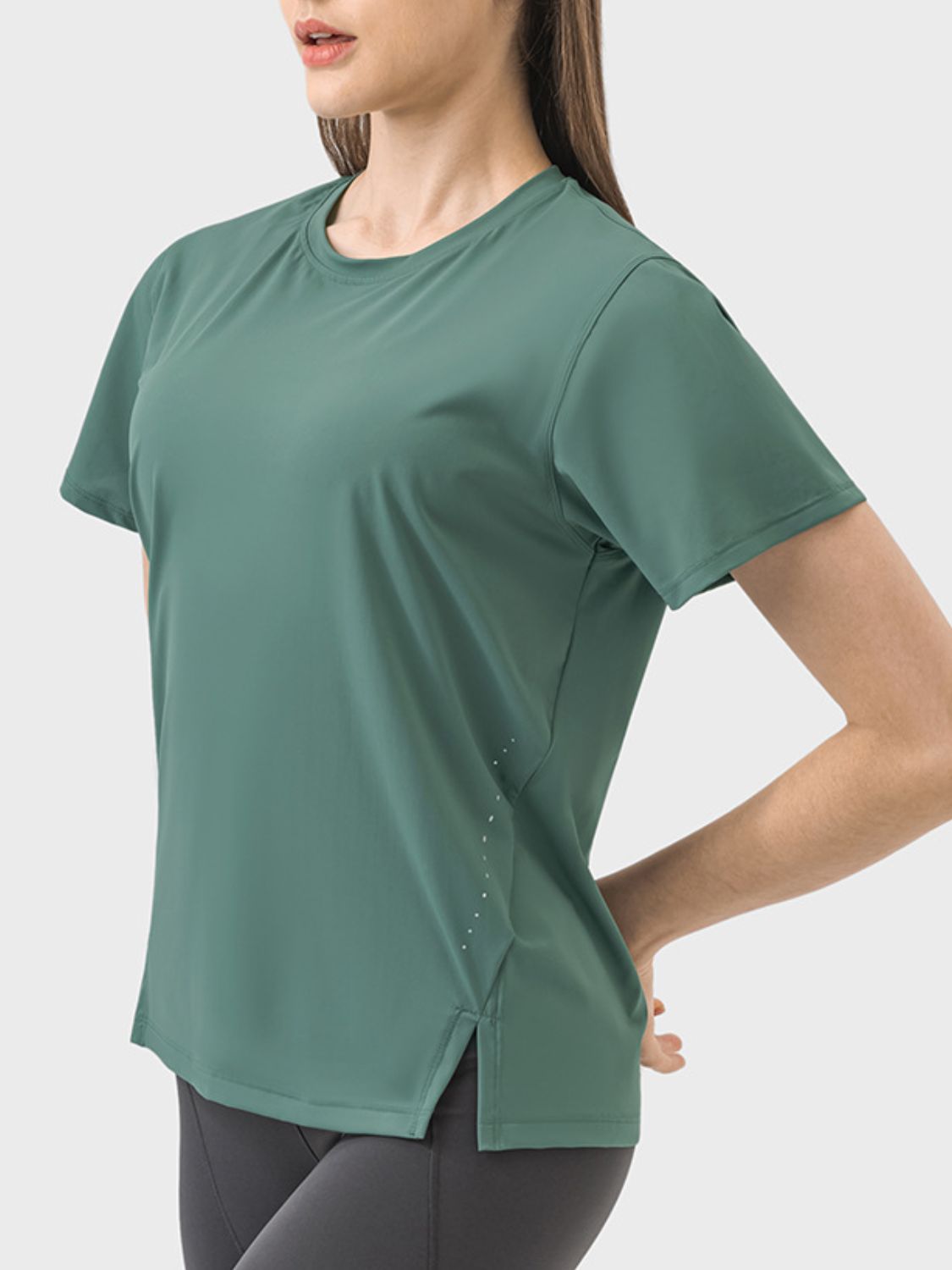 Dark green performance t-shirt with short sleeves, crew neck, and slit hem detail.