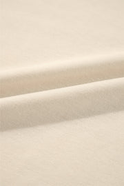 Cream sweatshirt fabric detail showing soft texture and subtle ribbing.