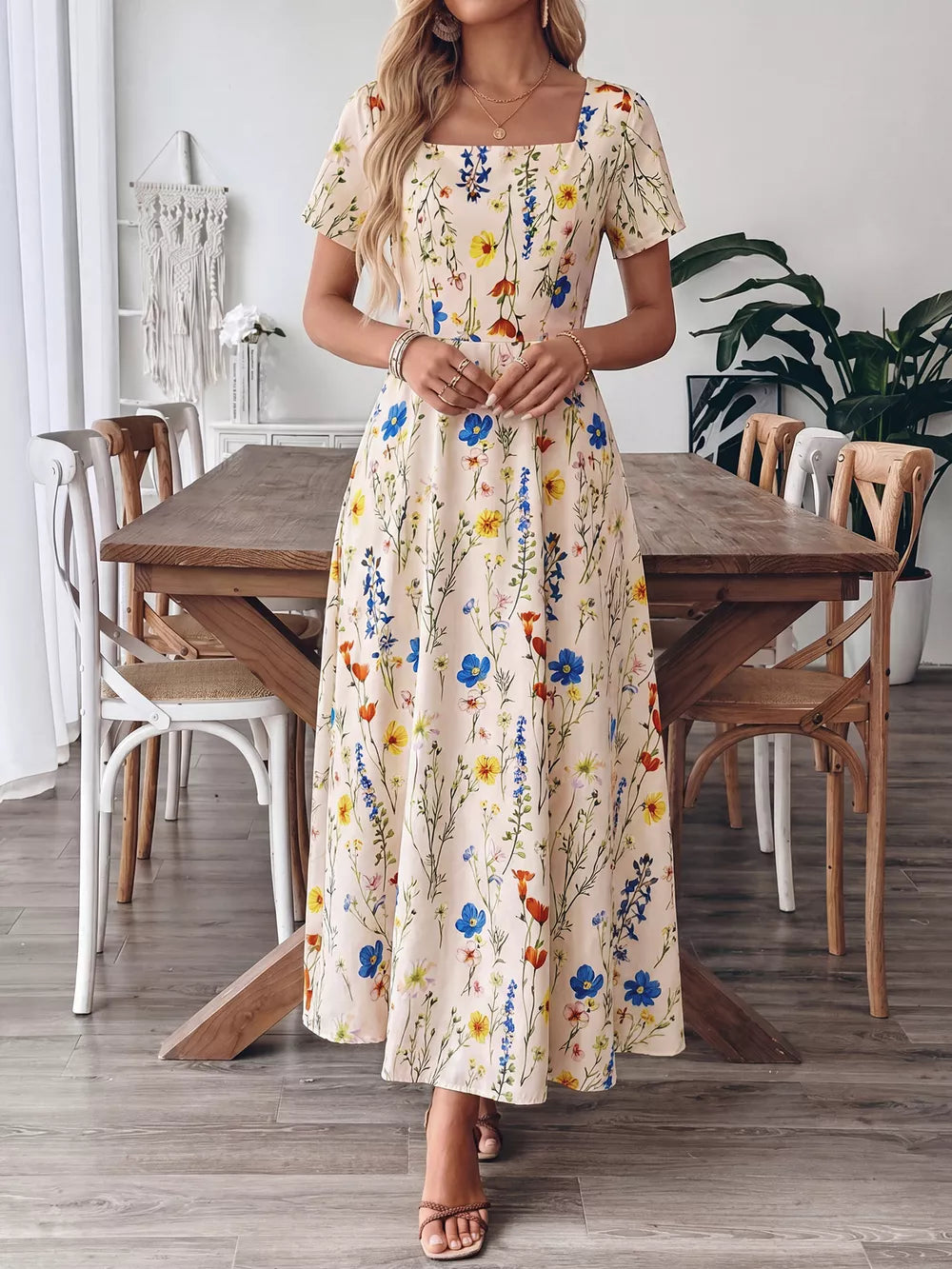 A-line maxi dress with square neckline and short sleeves in a cream floral print.