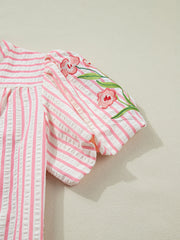 Pink and white striped blouse with floral embroidery on puff sleeves.