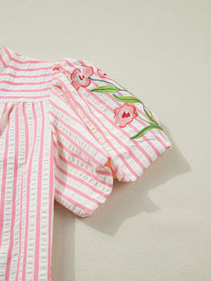 Pink and white striped blouse with floral embroidery on puff sleeves.