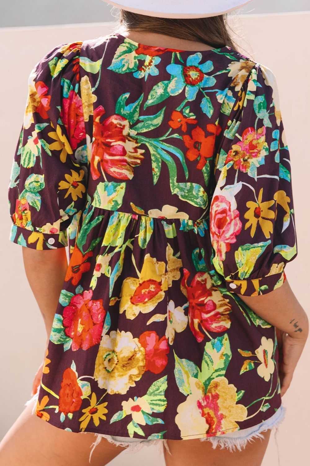 Embroidered floral babydoll blouse with puff sleeves and a gathered waist.