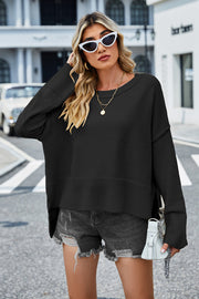 Black acrylic knit sweater with flared sleeves and split hem detail.