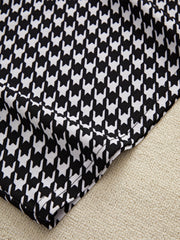 Black houndstooth pencil skirt detail with off-shoulder top fabric texture.