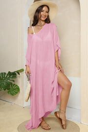 Pink oversized caftan cover-up with side slits and V-neck, styled with a straw hat and sandals.