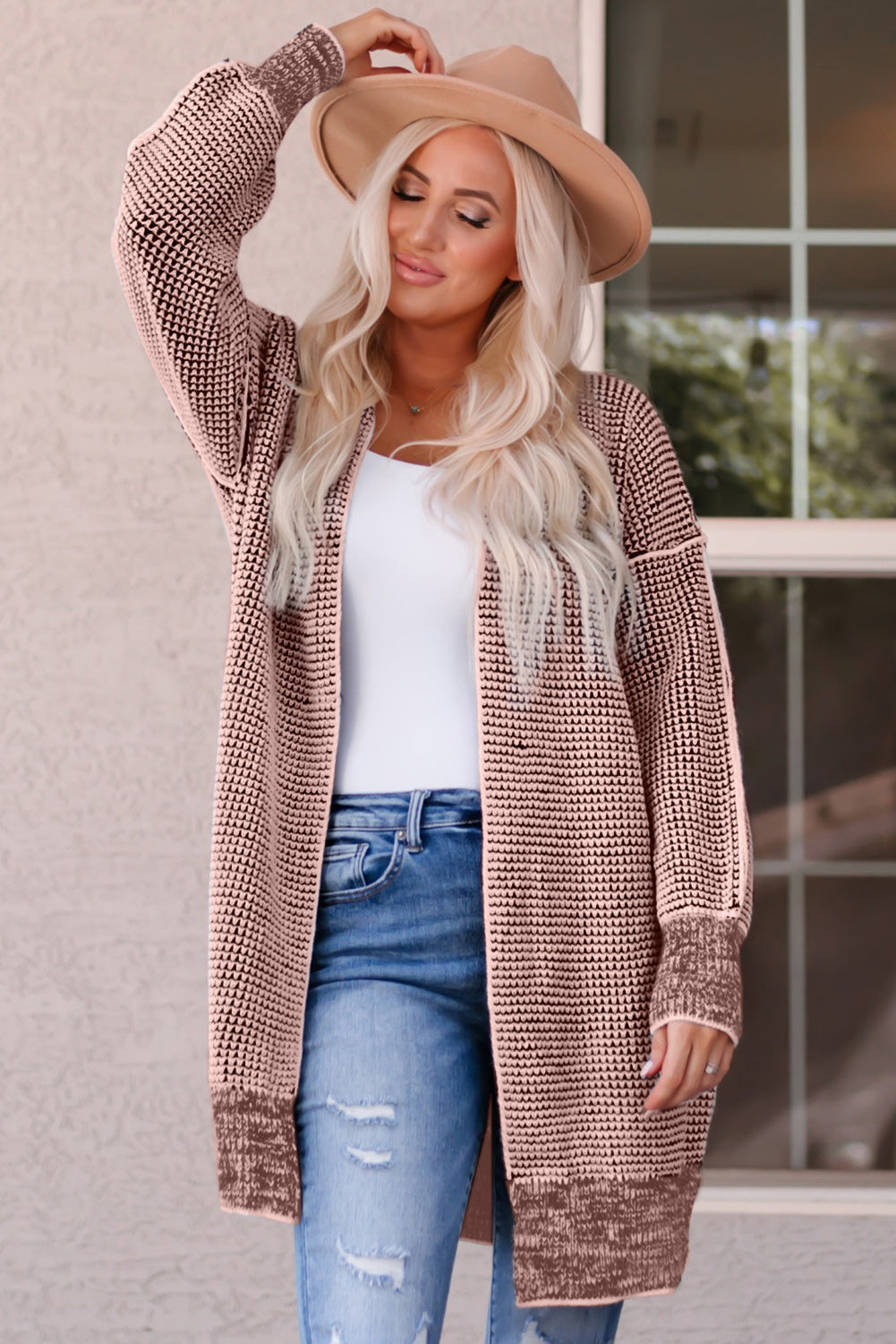Textured puff sleeve open cardigan in pink with a knit pattern and ribbed cuffs.
