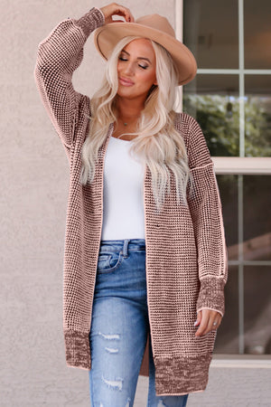 Textured puff sleeve open cardigan in pink with a knit pattern and ribbed cuffs.