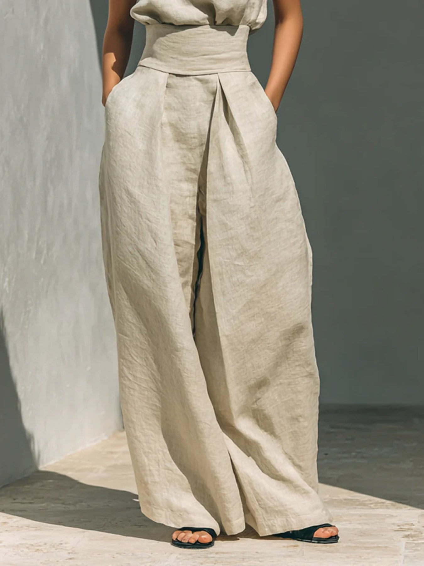 Ivory linen mock-neck top and wide-leg pants set with a high waist and pleats.