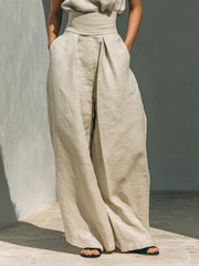 Ivory linen mock-neck top and wide-leg pants set with a high waist and pleats.