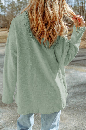 Sage textured shacket with raw-edge detailing and button closure.