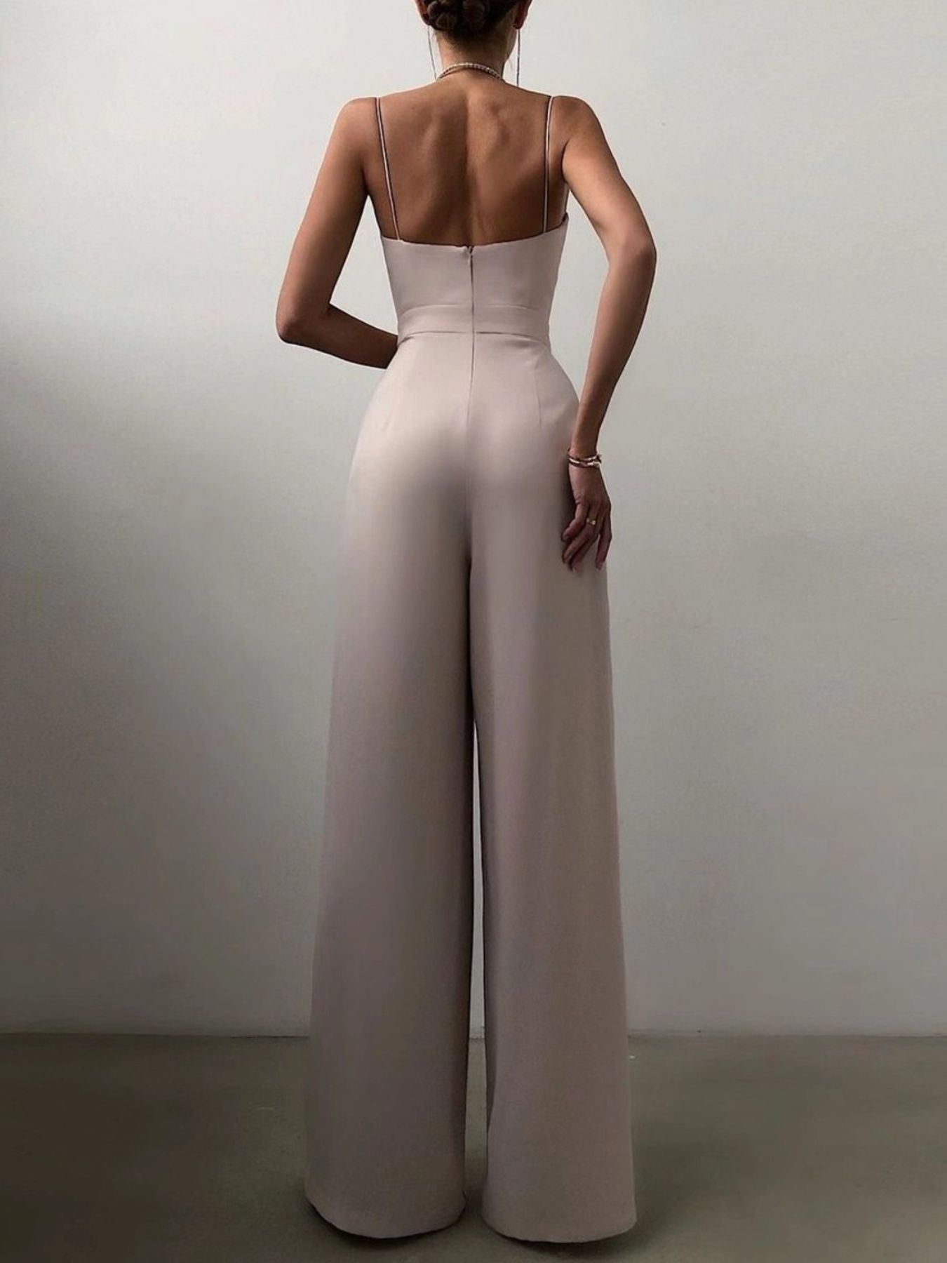 Ruched spaghetti strap wide-leg jumpsuit in Lotus Root, with a fitted bodice and flowing pants.