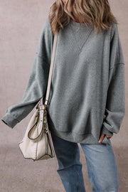 Relaxed fit dark gray ribbed sweatshirt with crew neck and V-stitch detail.