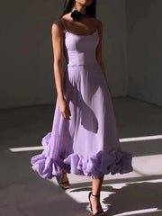 Lavender midi dress with spaghetti straps and a ruffled hem.