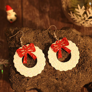 Glitter wreath drop earrings with red bows, white glitter wreaths.