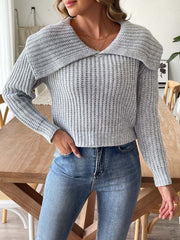 Gray ribbed knit sweater with a shawl collar and long sleeves, styled with jeans.