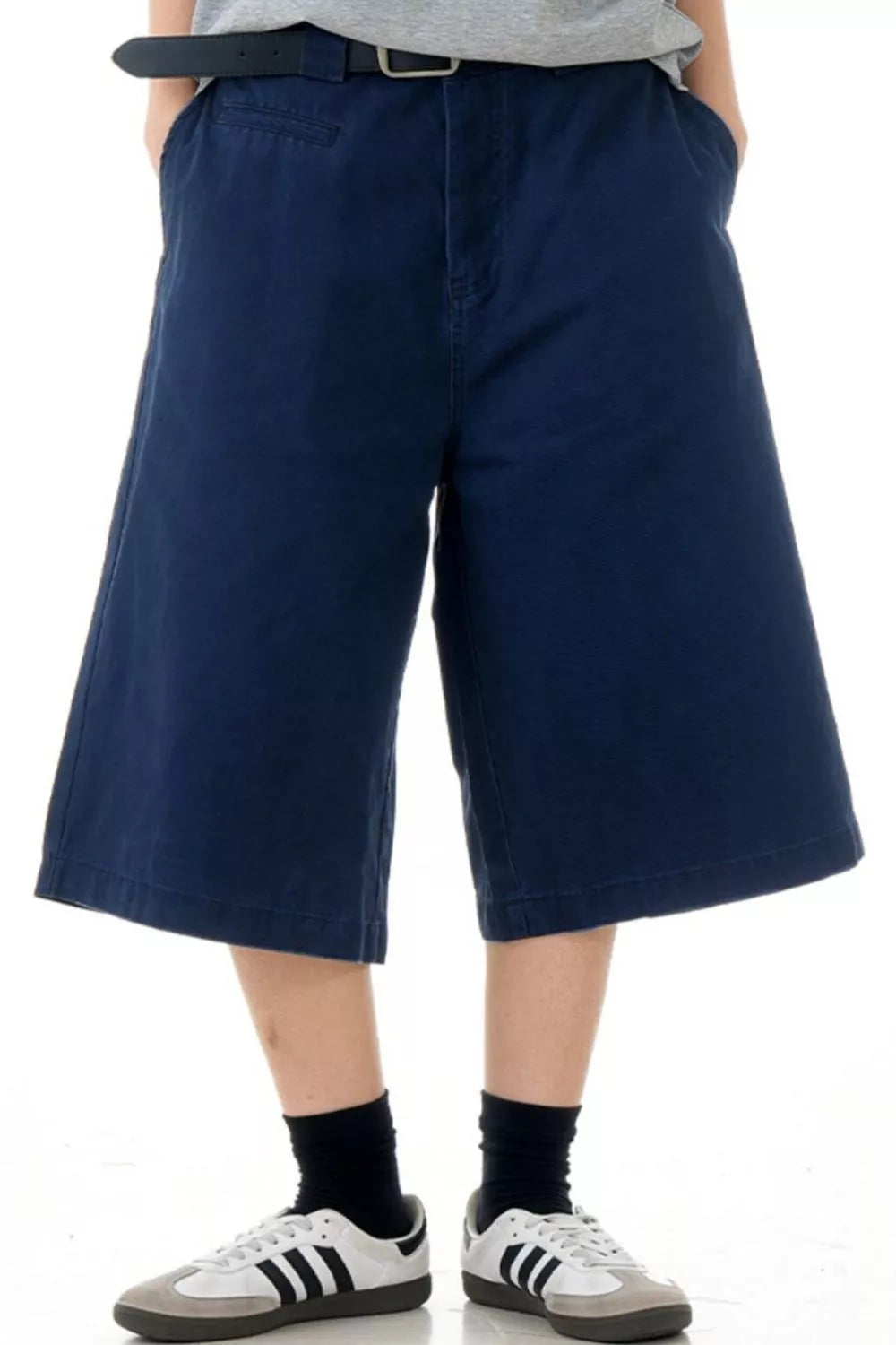 Navy blue relaxed fit bermuda shorts with pockets and belt loops.