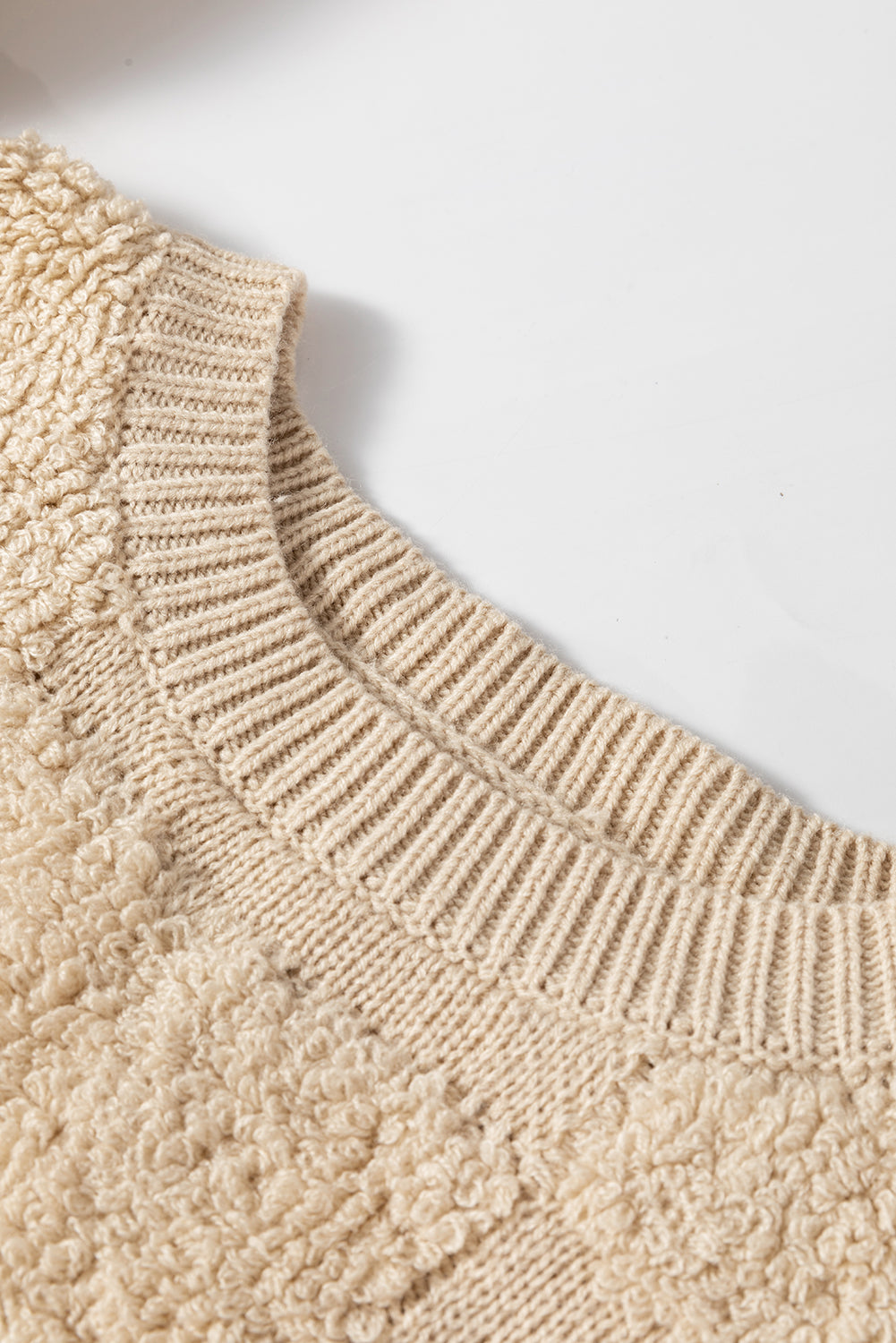 Beige textured checkerboard knit sweater with crew neck and ribbed details