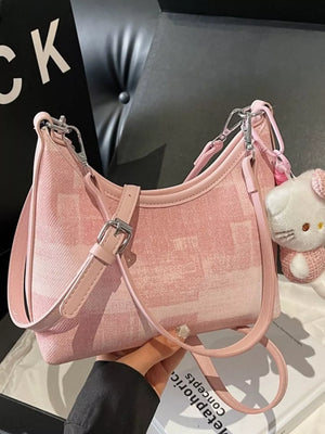 Pink pu leather shoulder bag with subtle pattern and buckle detail