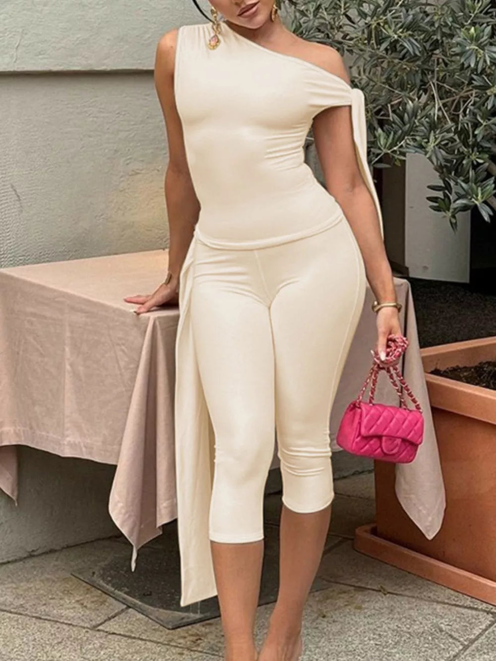 Apricot asymmetrical one-shoulder top with capri pants.