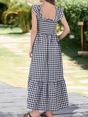 Black gingham midi dress with smocked bodice, ruffled neckline and sleeves, tiered skirt.