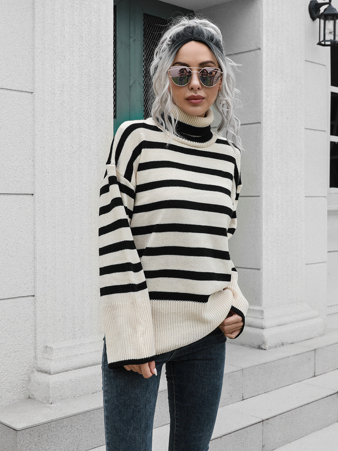 Flared sleeve striped turtleneck knit sweater in black and beige acrylic with a relaxed fit.