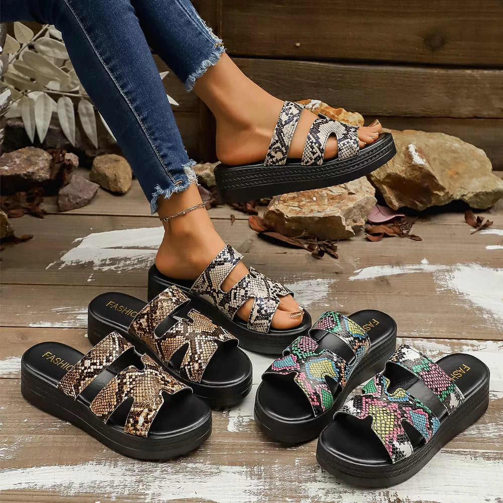 Distinctive two-strap platform sandals in snakeskin pattern with a black sole.