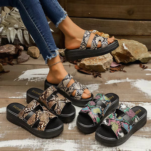 Distinctive two-strap platform sandals in snakeskin pattern with a black sole.