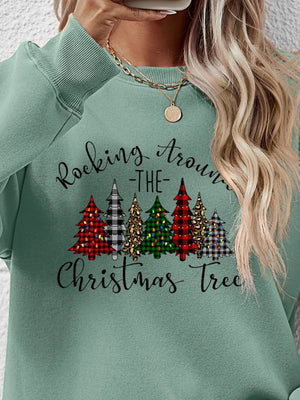 Sage green crewneck sweatshirt with graphic Christmas trees and text.