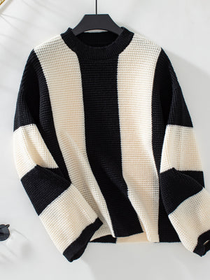 Colorblock stripe knit sweater in black and cream waffle knit with crewneck and long sleeves.