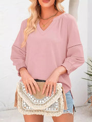 Light Pink polyester blouse with smocked cuffs, V-neck, and lace detail on sleeves.