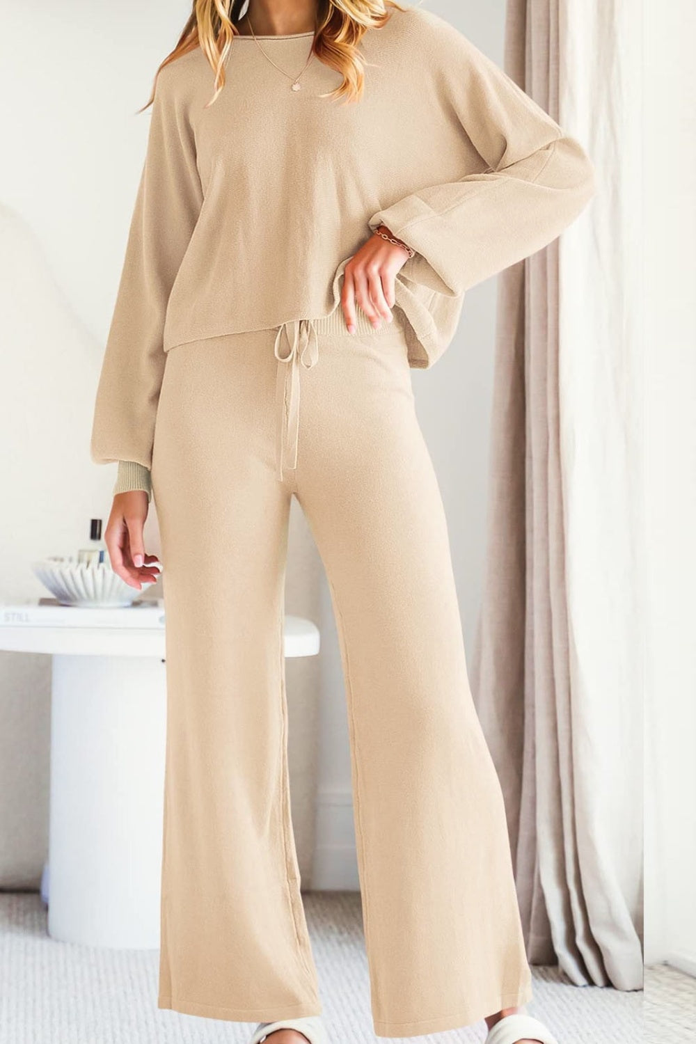 Tan knit lounge set with balloon sleeves and wide-leg pants with drawstring waist.