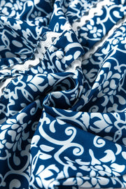 Peacock blue polyester blouse with indigo medallion print and white lace trim detail.