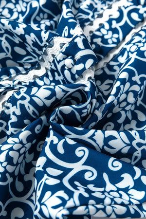 Peacock blue polyester blouse with indigo medallion print and white lace trim detail.