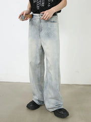 Faded denim palazzo pants with a relaxed, oversized fit and light wash.