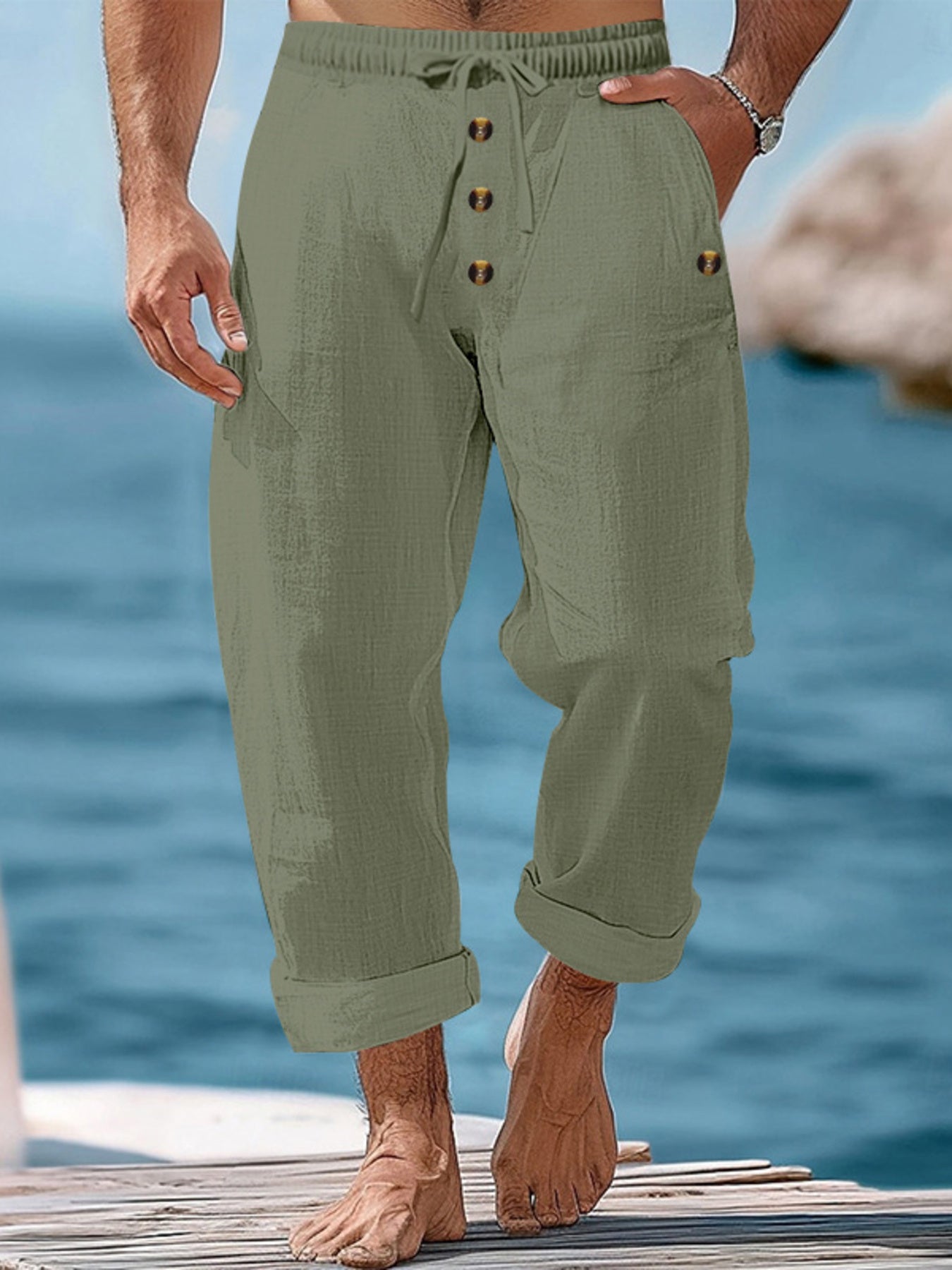 Relaxed fit military green cotton sweatpants with drawstring and button fly.