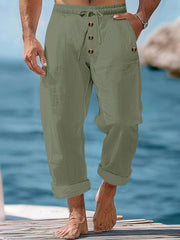 Relaxed fit military green cotton sweatpants with drawstring and button fly.
