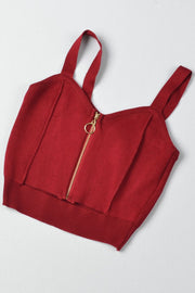Burgundy ribbed knit crop top with exposed gold zipper and ring pull.