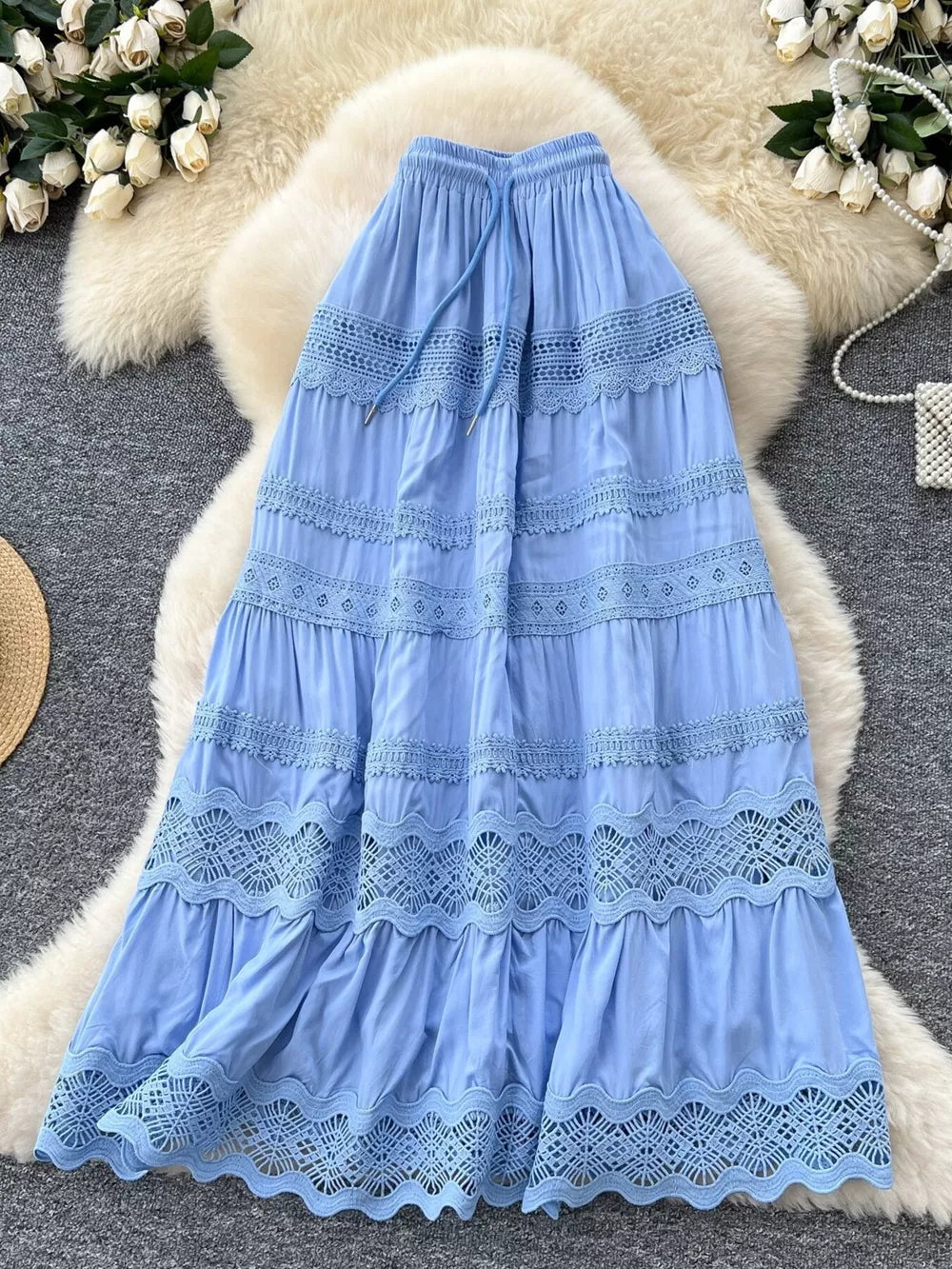 Blue tiered maxi skirt with lace trim and drawstring waist.