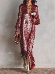 Wine red sequin maxi gown with lantern sleeves and a V-neck, styled with gold boots and clutch.