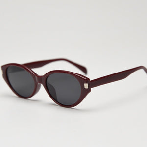 Burgundy cat-eye sunglasses with dark lenses and acetate frames.