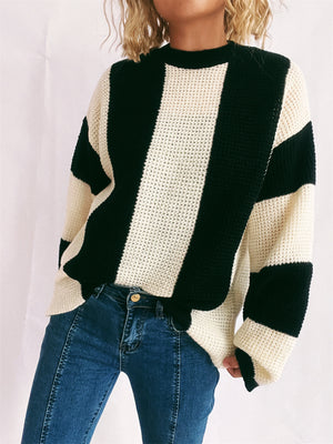 Black and cream vertical stripe waffle knit sweater with crew neck.