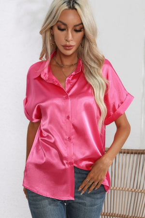 Hot pink satin button-down blouse with cuffed short sleeves and a collared neckline.
