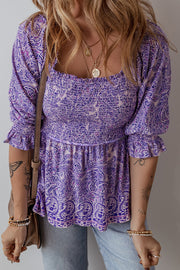 Paisley smocked bodice blouse in lavender with square neckline and puff sleeves.