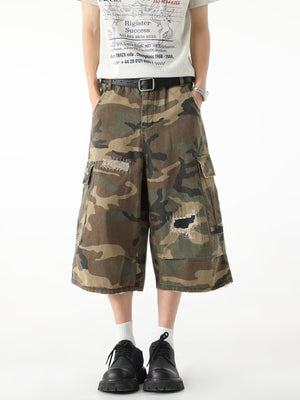 Men's camo cargo denim shorts with distressed patches and raw hem
