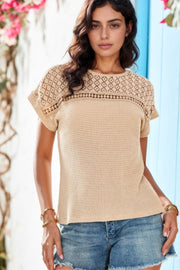 Beige waffle knit top with lace yoke and short sleeves.