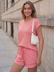 Pink striped tee and drawstring shorts ensemble with a white shoulder bag.