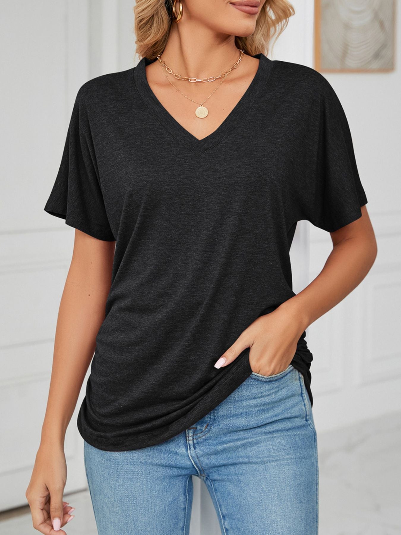 Relaxed V-neck short sleeve t-shirt in dark grey with a draping fit.