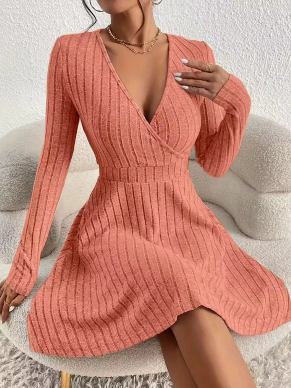 Burnt Coral ribbed wrap mini dress with long sleeves and a V-neckline.