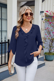 Dark blue V-neck flutter sleeve blouse with ruffled front detail.